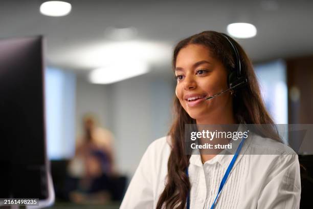young woman working in customer service - callcenter bildbanksfoton och bilder