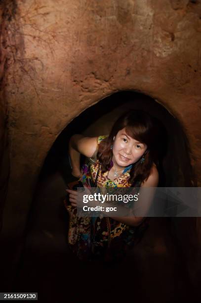 female asian traveler exploring the cu chi tunnels at ho chi minh city, vietnam - vietnamese military stock pictures, royalty-free photos & images