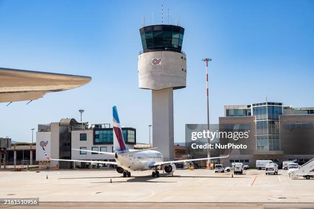 Eurowings airplane and the Control Tower are being pictured at Olbia Costa Smeralda Airport in Sardinia, Italy, on July 13, 2024.
