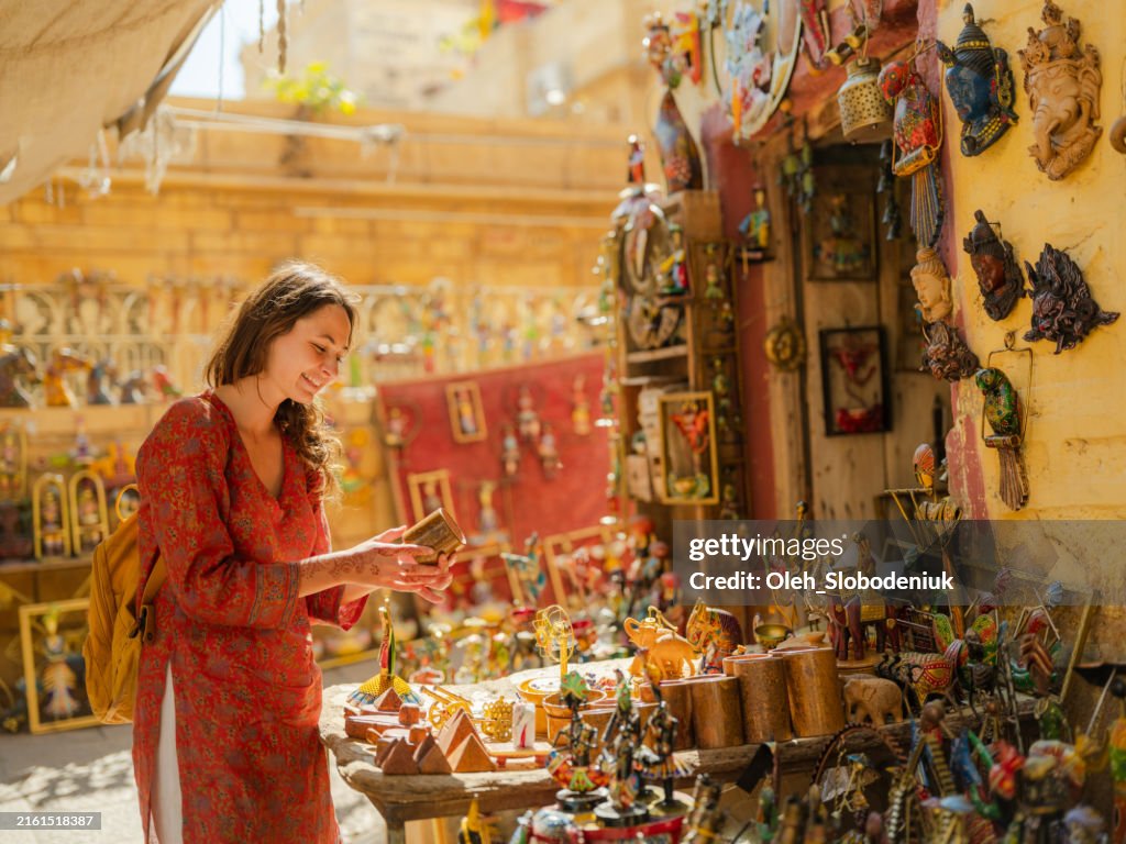 Woman choosing antique during culture trip to India