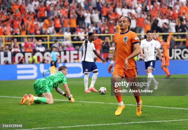 Xavi Simons of the Netherlands celebrates scoring his team's first goal during the UEFA EURO 2024 semi-final match between Netherlands and England at...