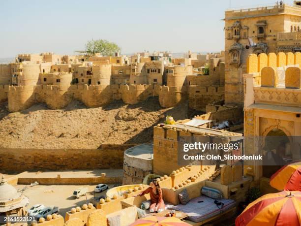 woman on the balcony at jaisalmer fort - jaisalmer fort stock pictures, royalty-free photos & images