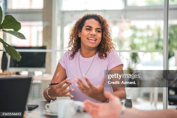 strategizing with generation z non-binary hispanic entrepreneur in meeting - nonbinary stock pictures, royalty-free photos & images