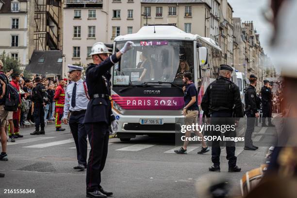 Bus of the entourage responsible for passing the olympic torch passes near Notre-Dame Cathedral. On the day of the Bastille Day festivities, Paris...