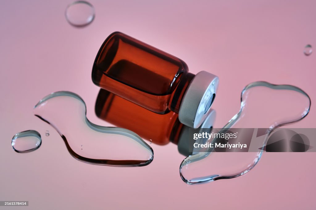 Bottles for injections on a pink background.