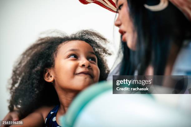 woman calming and hugging little daughter - step mother stock pictures, royalty-free photos & images