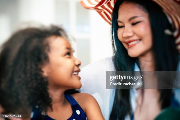 woman calming and hugging little daughter - step mother stock pictures, royalty-free photos & images