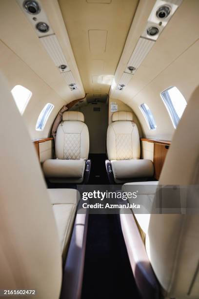 luxury private jet interior offering comfort and convenience - corporate jet stock pictures, royalty-free photos & images