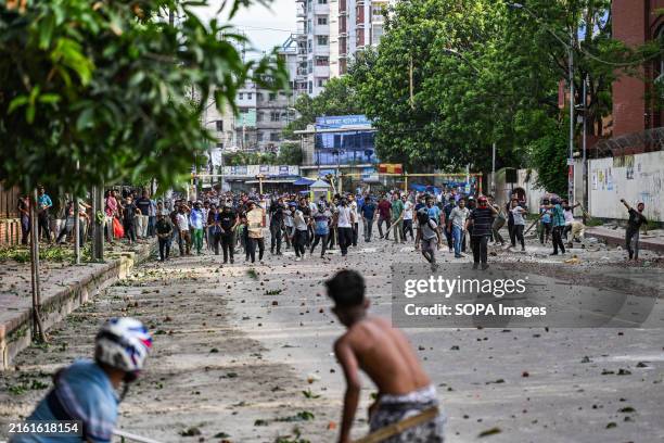 Anti-quota protesters and students supporting the Ruling Awami League Party clash on Dhaka University Campus. Rival student groups clashed in...