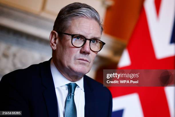 British Prime Minister Keir Starmer reacts as he meets with Defence Secretary John Healey and Member of the House of Lords George Robertson at 10...