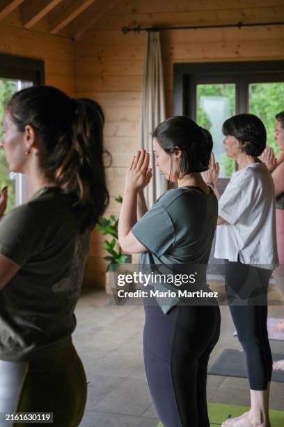 a group of people practicing yoga during retreat - retreating stock pictures, royalty-free photos & images