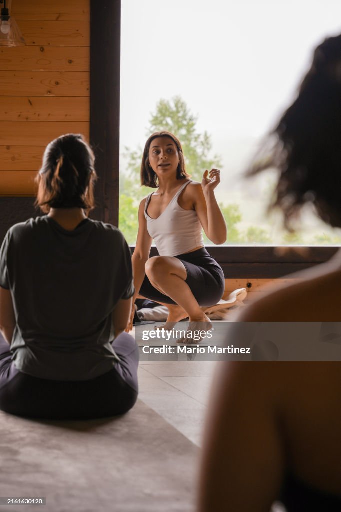 Teacher Explains Yoga Technique To Diverse Group
