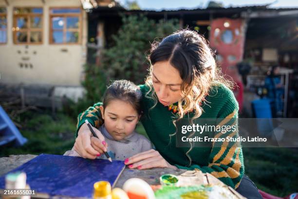teacher and student doing painting activity at children's foundation - art and craft stock pictures, royalty-free photos & images