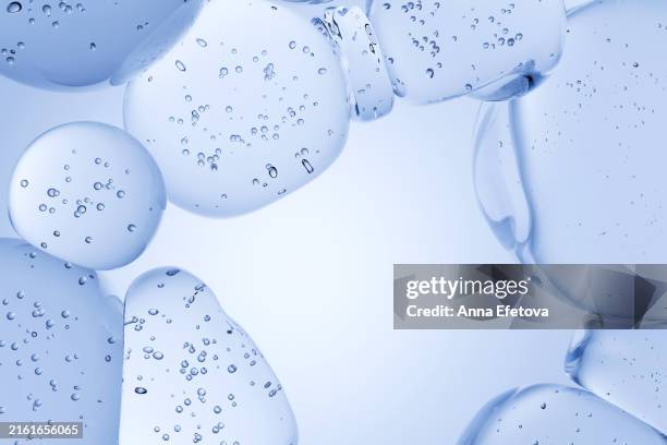 serum drops on pastel blue background. cosmetics concept, place for text. macro, cgi - cell structure stock pictures, royalty-free photos & images