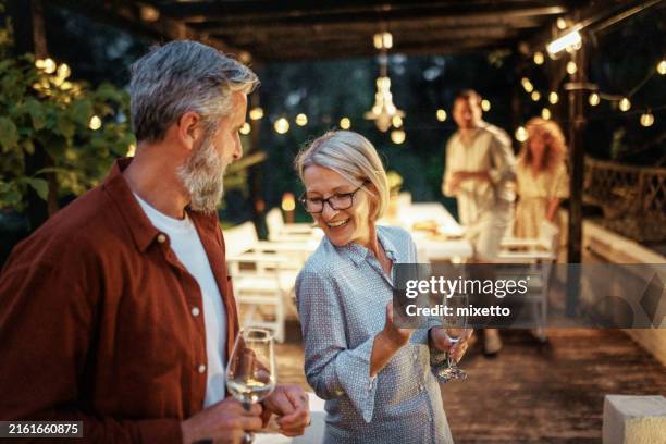mature couple dancing during backyard diner party - dinner party stock pictures, royalty-free photos & images
