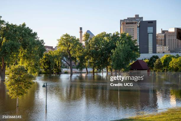 St. Paul, Minnesota, Evening view of the flooding of the Mississippi river taking over Harriet Island Regional Park just below the city skyline.