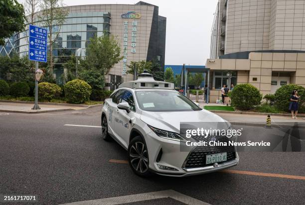 Robotaxi operated by Pony.ai drives on the road at Beijing High-level Autonomous Driving Demonstration Area on July 11, 2024 in Beijing, China.