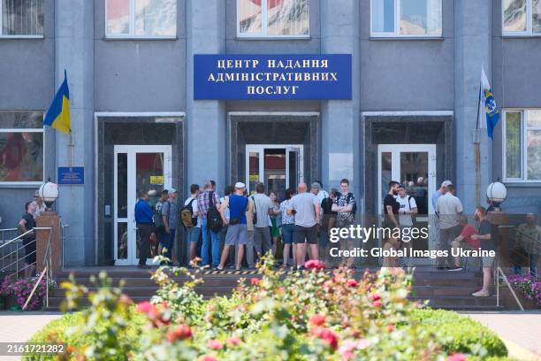 Ukrainian conscripts wait in queues outside the Administrative Services Center to update their registration data on July 12, 2024 in Kyiv, Ukraine....