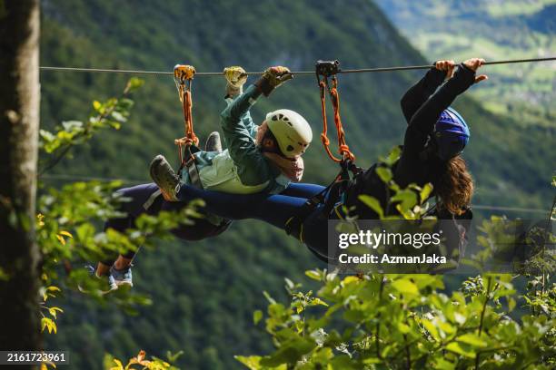 diverse group enjoying zipline adventure in nature - teambuilding bildbanksfoton och bilder