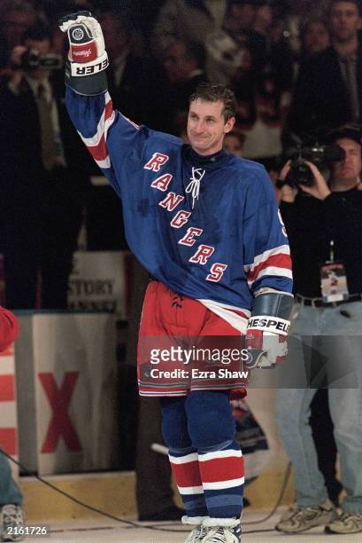 Wayne Gretzky of the New York Rangers waves to the crowd from the ice after playing in his final career game against the Pittsburgh Penguins at the...