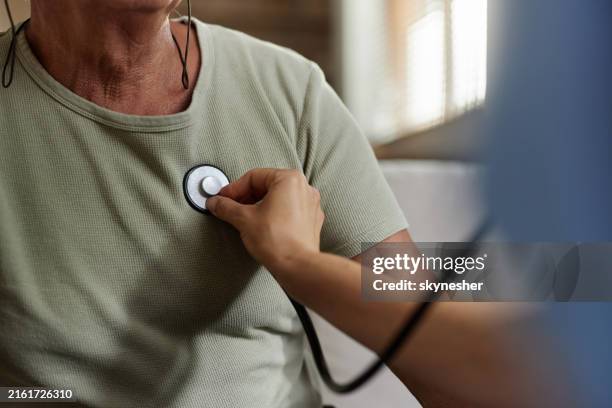 listening to patient's heartbeat! - nurse checking heart beat stock pictures, royalty-free photos & images