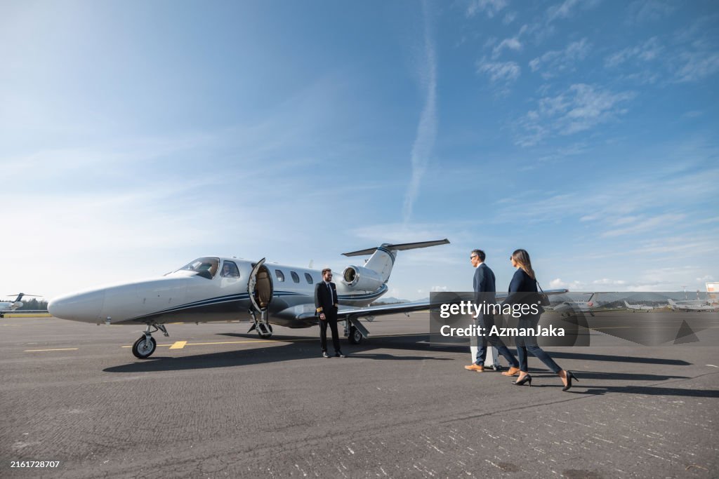 Business Executives Walking to Private Jet for Exclusive Travel