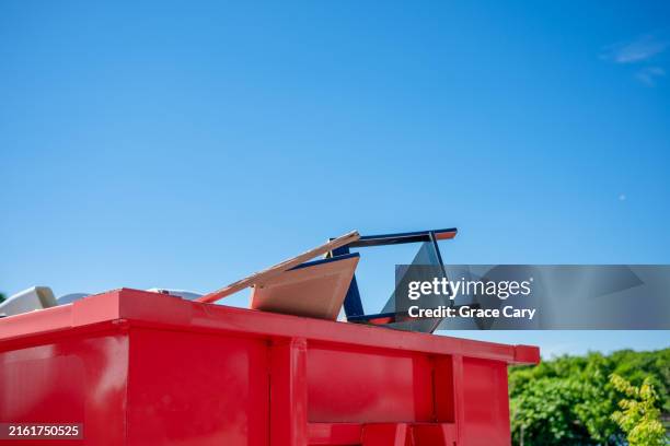 red dumpster against clear blue sky - müllcontainer stock-fotos und bilder