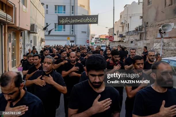 Shiite Muslims take part in the rituals of Ashura, commemorating the 7th century killing of Prophet Muhammad's grandson Imam Hussein, in Sanabis on...