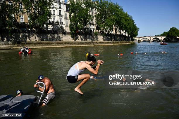 Local resident dives in the Seine, in Paris on July 17 after the mayor of Paris swim in the river to demonstrate that it is clean enough to host the...