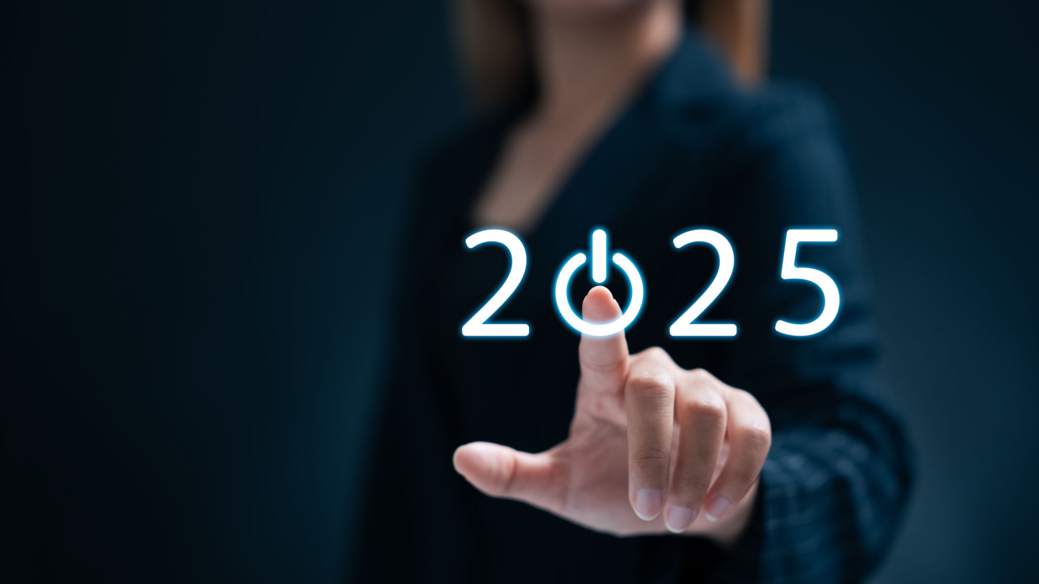 A businesswoman taps a start button for New Year 2025 to set goals and develop strategy. A businesswoman taps a start button for New Year 2025 to set goals and develop strategy.