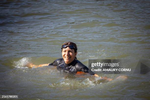 Paris Mayor Anne Hidalgo bathes and swims in a wetsuit and goggles in the Seine water at Bras Marie in Paris, France on July 17, 2024. Proof and...