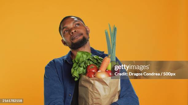 male model thinking about new vegan food recipe to cook - male fitness model diet fotografías e imágenes de stock