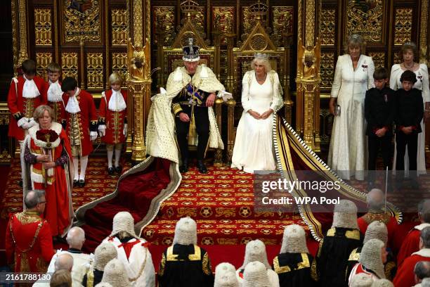 King Charles III, wearing the Imperial State Crown and the Robe of State, sits alongside Britain's Queen Camilla, wearing the George IV State Diadem,...