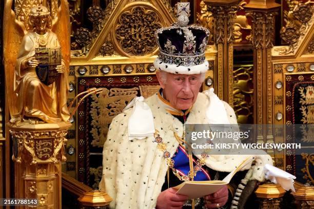 Britain's King Charles III, wearing the Imperial State Crown and the Robe of State, reads the King's Speech from the The Sovereign's Throne in the...