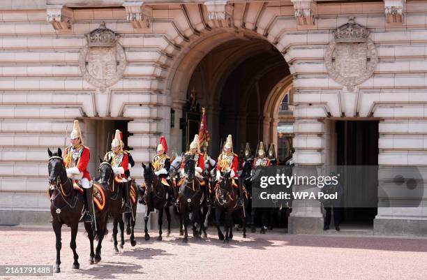 Members of the Life Guards make their way out of the quadrangle at Buckingham Palace after taking part in a Rank and March Past following the State...