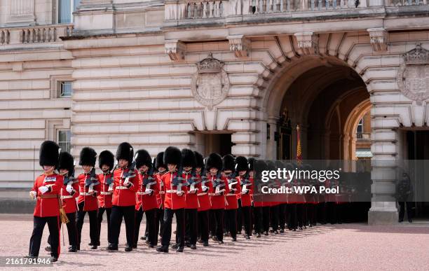 Members of the Welsh Guards march out of the quadrangle at Buckingham Palace after taking part in a Rank and March Past following the State Opening...
