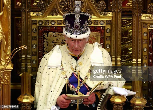 King Charles III, wearing the Imperial State Crown and the Robe of State, reads the King's Speech from the The Sovereign's Throne in the House of...