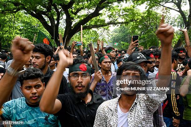 Students wearing headbands with Bangladesh's national flag shout slogans during a protest against quotas in government jobs at Dhaka University in...