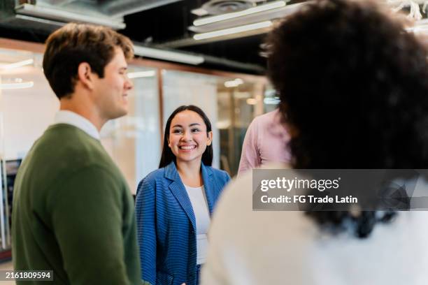 coworkers talking at office - trainee stock pictures, royalty-free photos & images