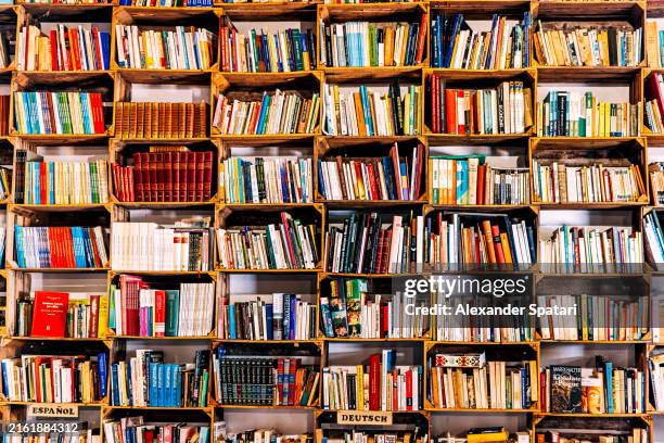 shelves with books in a book store - bibliotek bildbanksfoton och bilder