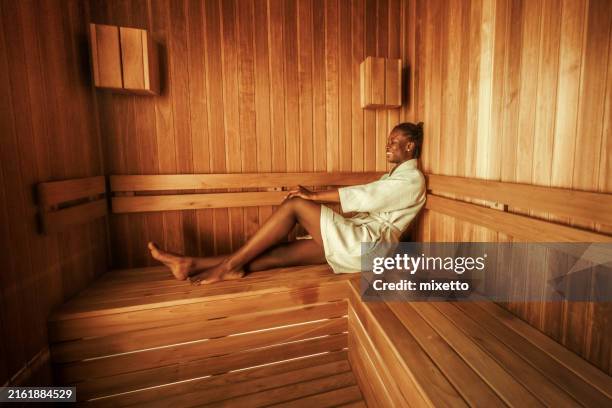 young beautiful woman enjoying her time in sauna - sauna stock pictures, royalty-free photos & images