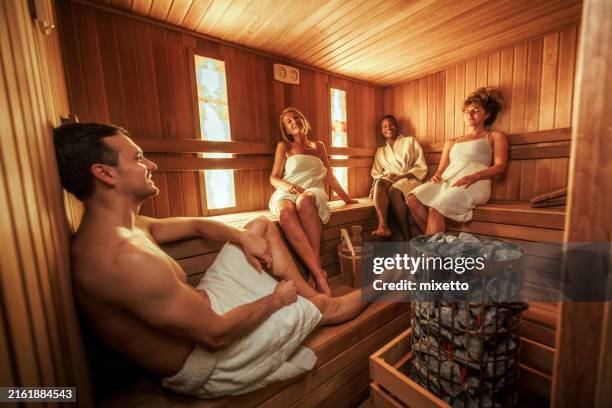 group of friends enjoying their day in sauna - sauna stockfoto's en -beelden