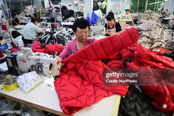 Workers are producing cotton clothing at a workshop in Liaocheng, China, on July 17, 2024.