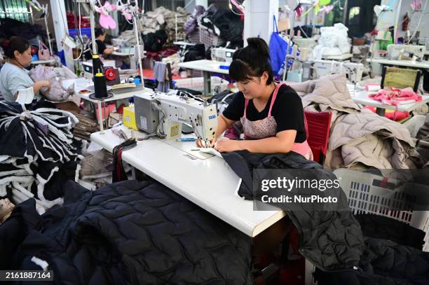 Workers are producing cotton clothing at a workshop in Liaocheng, China, on July 17, 2024.