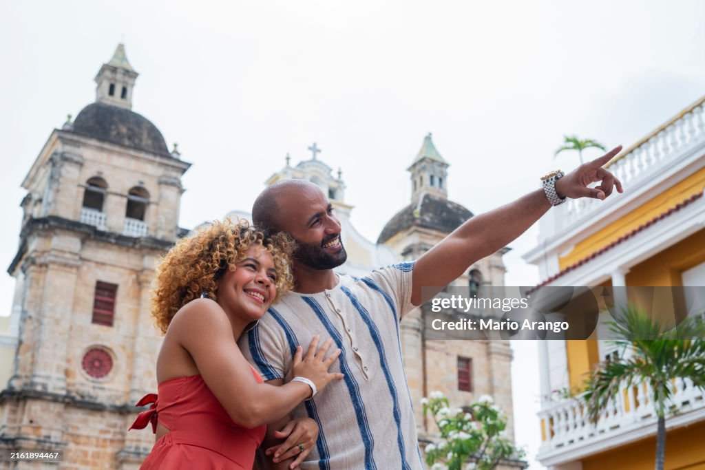 Newly married couple walking through the streets of beautiful Cartagena de Indias during their honeymoon