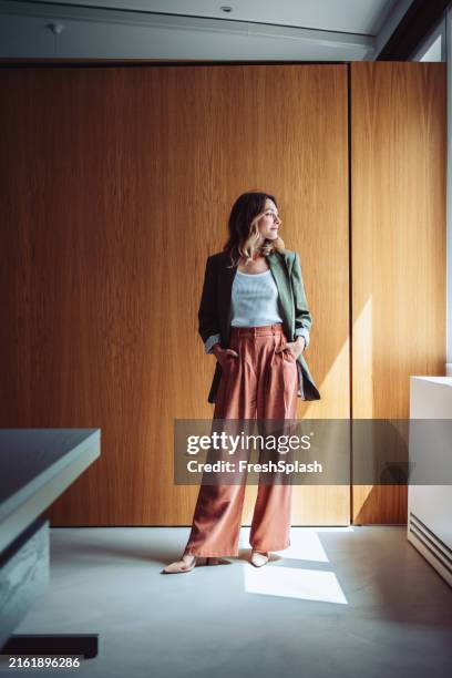 confident businesswoman posing in modern office wearing trendy outfit - full length stock pictures, royalty-free photos & images