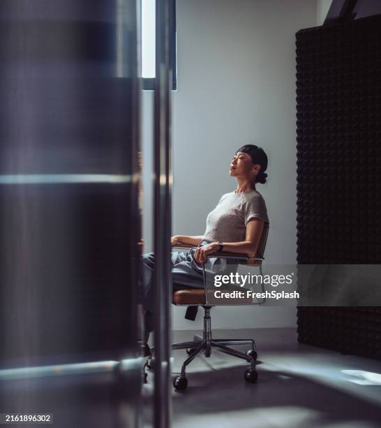 businesswoman taking a break in modern office setting - weekend activiteiten stockfoto's en -beelden
