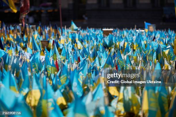 Makeshift memorial made of thousands of personalized small flags to fallen defenders of Ukraine, organized by people on Maidan Nezalezhnosti,...
