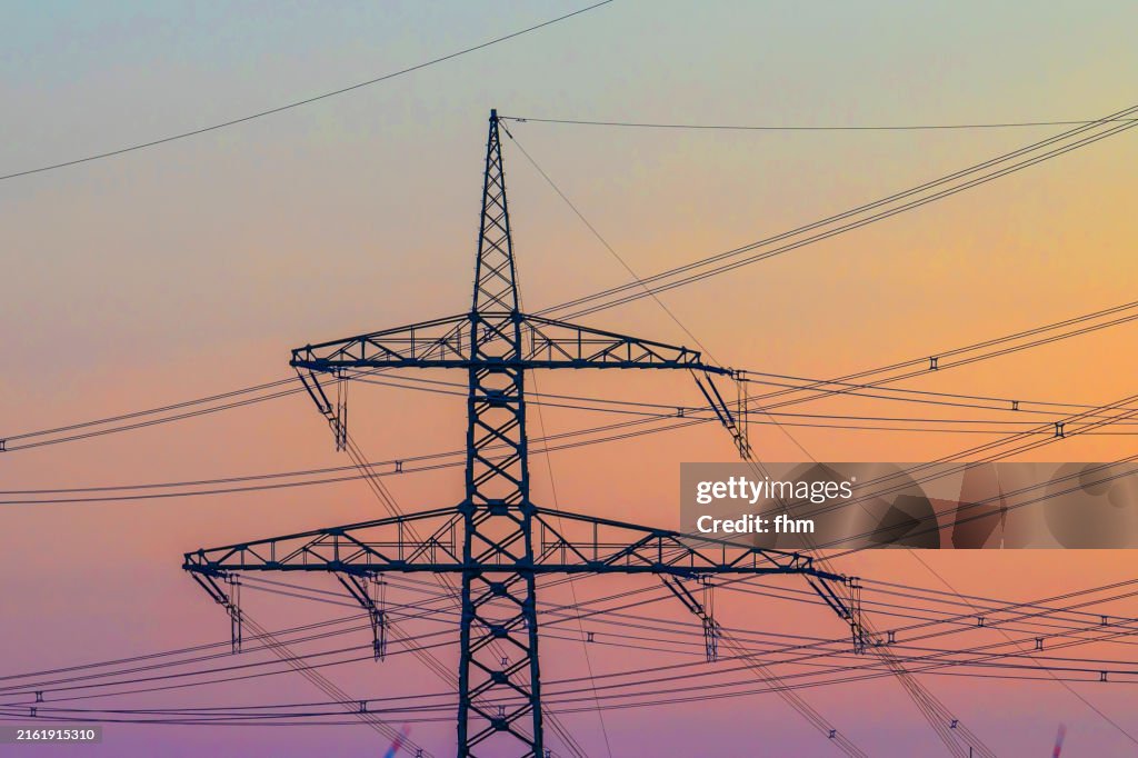 Large electricity pylon at sunset