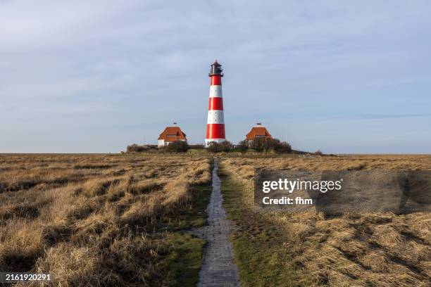 travel destination: westerhever lighthouse (schleswig-holstein, germany) - wattenmeer national park schleswig holstein stock pictures, royalty-free photos & images